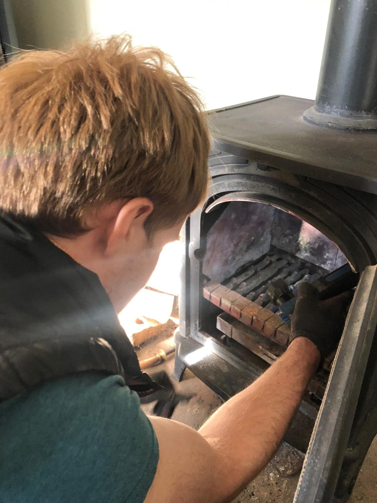Servicing the firebox and grate of a wood burning stove